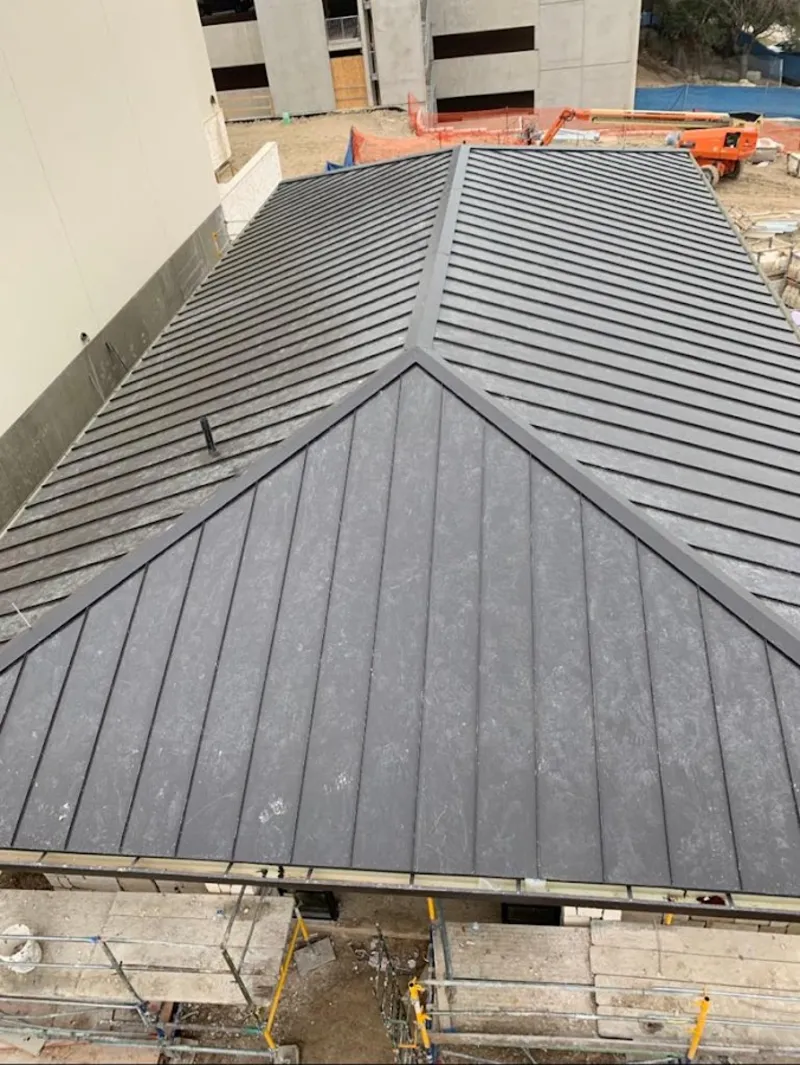 Commercial metal roof construction with crane equipment in Gautier
