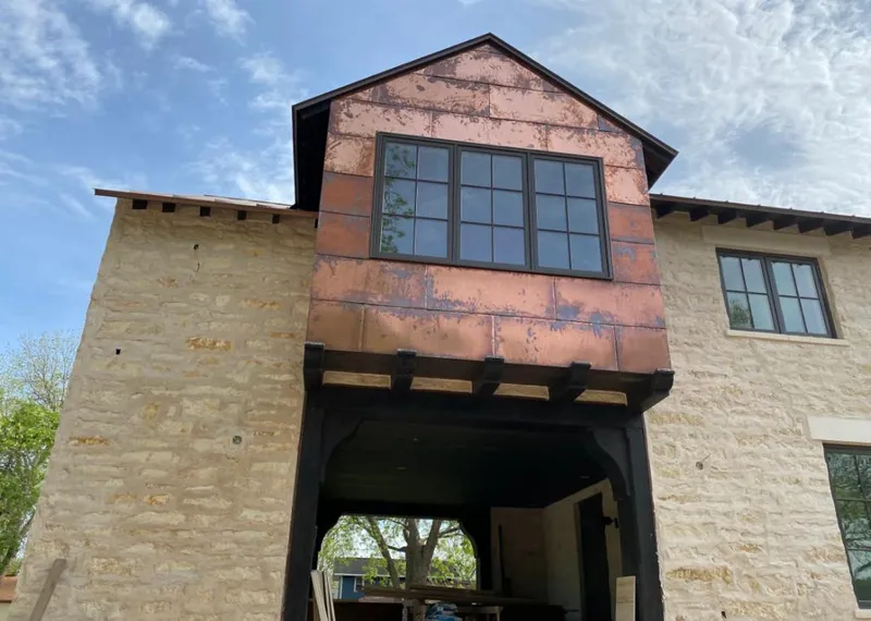 Copper metal panel facade on a stone building for Metal Roof Coating in Gautier
