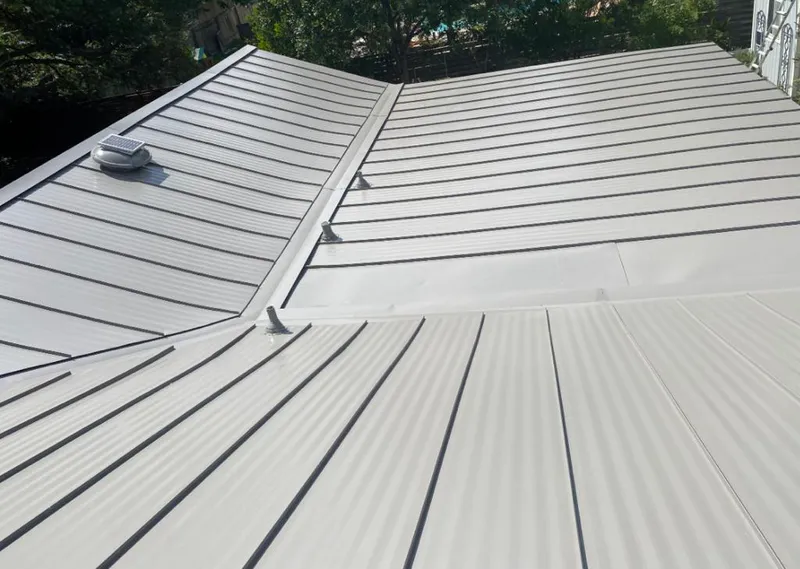Solar attic fan installed on a metal roof for Roof Ventilation in Gautier